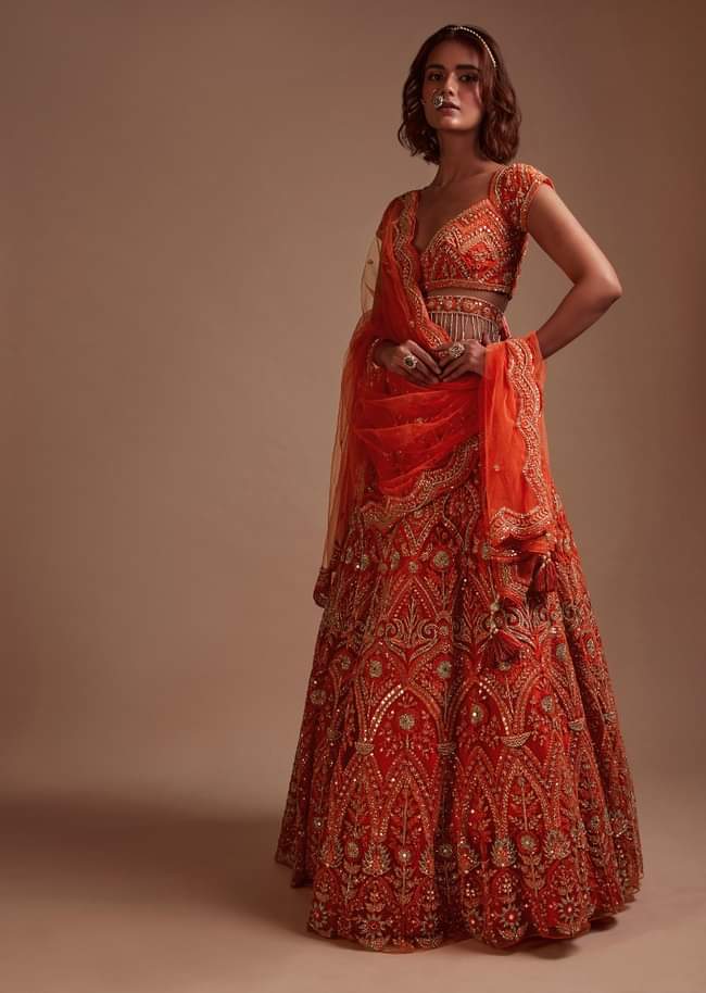 Coral Orange Lehenga Choli In Net With Mirror And Sequins Embroidered Floral And Mughal Embroidery Along With Belt Detailing 