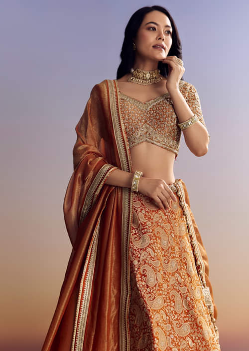 Orange Banarasi Lehenga With Embroidered Choli And Dupatta Orange Banarasi Lehenga With Embroidered Choli And Dupatta
