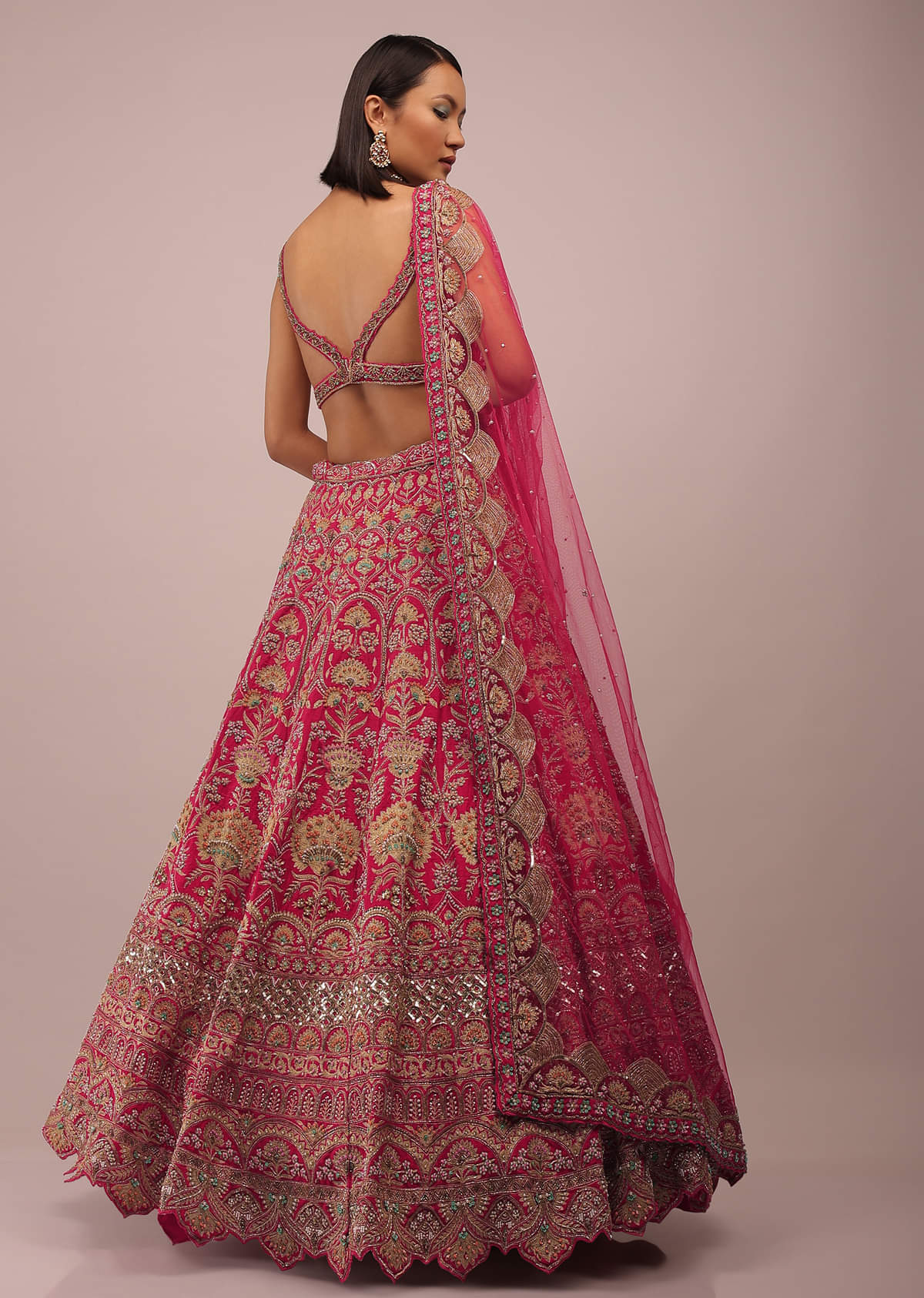 Rani Pink Lehenga In Golden Zari Work Embroidery Inspired By Mughal Architecture With Matching Net Dupatta In Embroidered Buttis