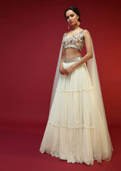 Powder White Lehenga Choli With Attached Cape And Hand Embroidery Using Colorful Resham And Sequins In Floral Motifs 